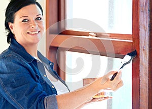 Woman, paint brush and portrait with varnish on window frame for home improvement and repair. Happy, smile and female