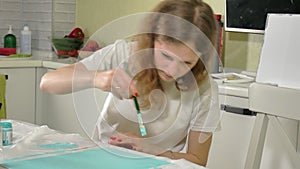 Woman paint with colored brush. Games with children affect the development of early children.