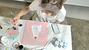 Woman paint with colored brush. Games with children affect the development of early children.