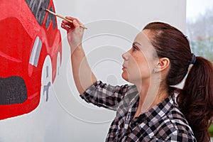 Woman paint little car