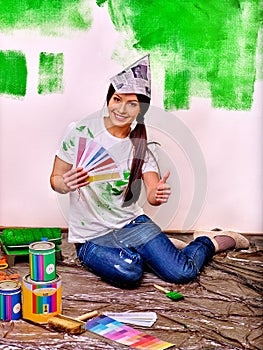 Woman paint wall at home