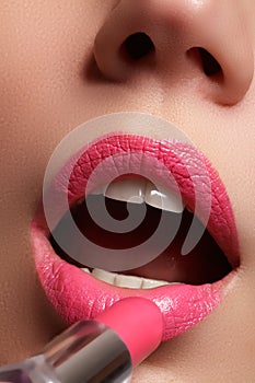 Woman painted pink lips. Beauty lips make-up. Perfect skin, full lips. Retro make up