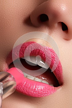 Woman painted pink lips. Beauty lips make-up. Perfect skin, full lips. Retro make up