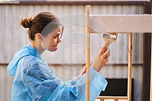 woman painter protective clothing wooden fittings renovation