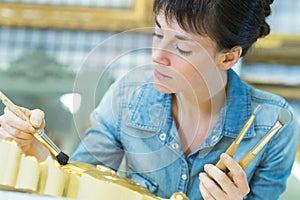 Woman painting a frame
