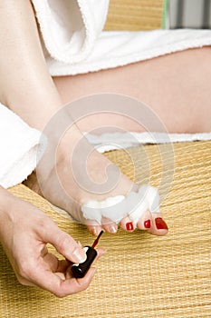 Woman painting her toe nails