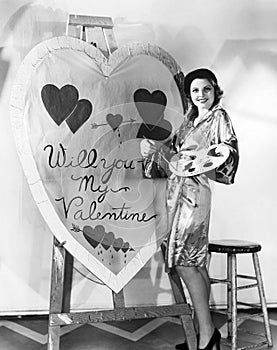Woman painting huge valentine