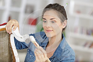 woman painting renewing chair at home