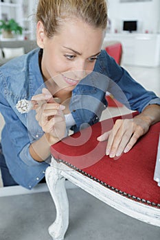 woman painting renewing chair at home