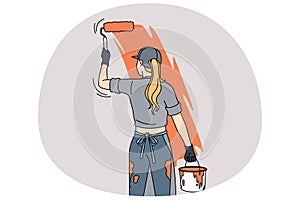 Woman painting room wall with roller