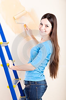 A woman is painting walls photo