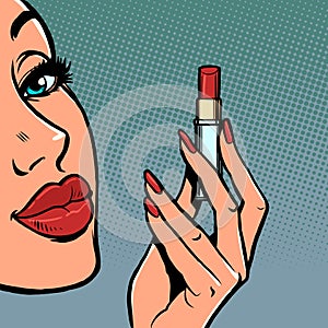 a woman paints her lips with red lipstick, makeup cosmetics