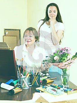 Woman paints a picture for her admirer