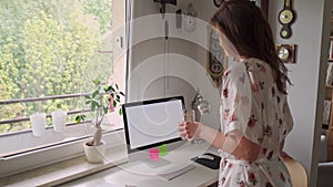 Woman in pajamas working remotely at home during a pandemic in slow motion