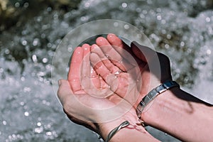 Hands with water on a river photo