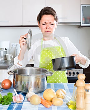 Woman with a pan of rotten food