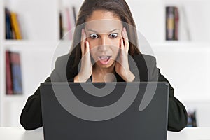 Woman in Panic Looking At A Computer Monitor