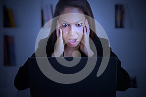 Woman in Panic Looking At A Computer Monitor