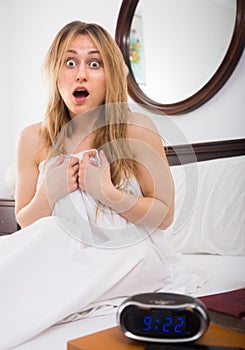 Woman in panic looks at clock