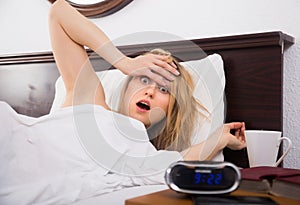 Woman in panic looks at clock