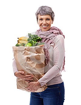 Woman, paper bag and portrait with vegetables for shopping, groceries and consumer for nutrition and fruits in studio