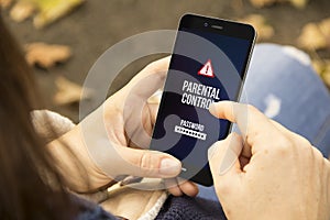 Woman with parental control phone in the park photo