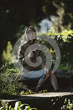 Woman in the park drinking yerba mate from a Mate cup.