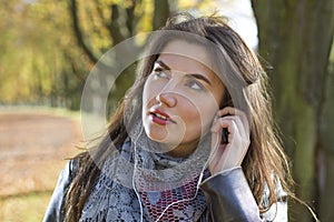 Woman in park with earphones