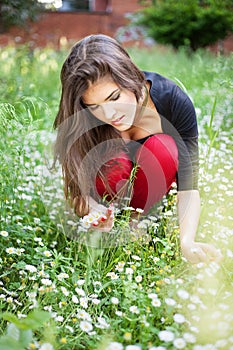 Woman in park gather spring flowers