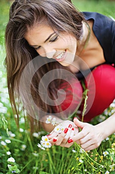 Woman in park gather spring flowers