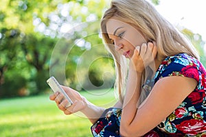 Woman in park with smart phone