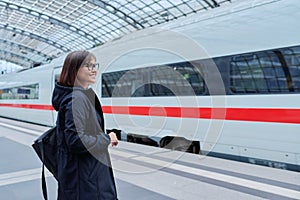 Woman passenger on railway platform inside station