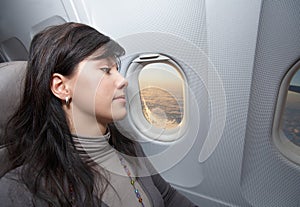 Woman is on passenger seat at airplane