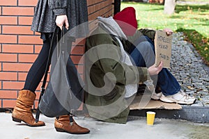 Woman passing by the homeless