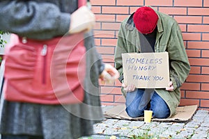 Woman passing poor man