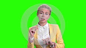 Woman passionately singing on green screen.