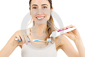 Woman pasting toothpaste to teethbrush