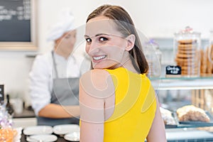 Woman in the pastry shop choosing sweet desserts