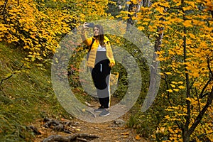 Woman path autumn forest. A young dark-haired woman in a yellow-black suit