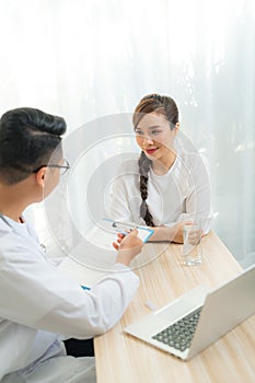 Woman patient consulting with doctor or psychiatrist on obstetric - gynaecological female illness, or mental health in medical