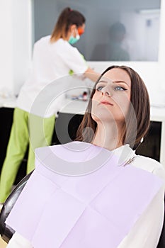 Woman patient at the dentist waiting to be checked up