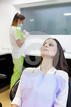 Woman patient at the dentist waiting to be checked up