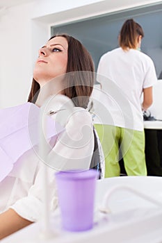 Woman patient at the dentist waiting to be checked up