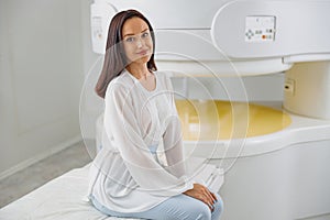 Woman patient is after doing magnetic resonance imaging MRI or CT scan in clinic