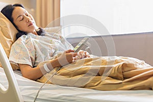 Woman patient hand using remote control for adjust level bed in hospital.