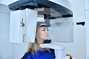 Woman patient make a panoramic computer tomograph in clinic