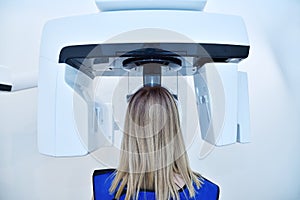 Woman patient make a x-ray picture on dental panoramic tomograph