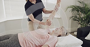 Woman patient, physiotherapist and stretching arms for rehabilitation and physical therapy. Senior person with a