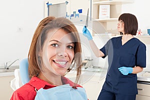 Woman patient smiling and female dentist doctor checking radiography