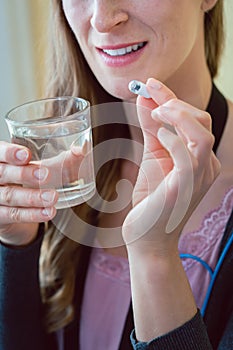 Woman patient swallowing capsule endoscopy video pill photo
